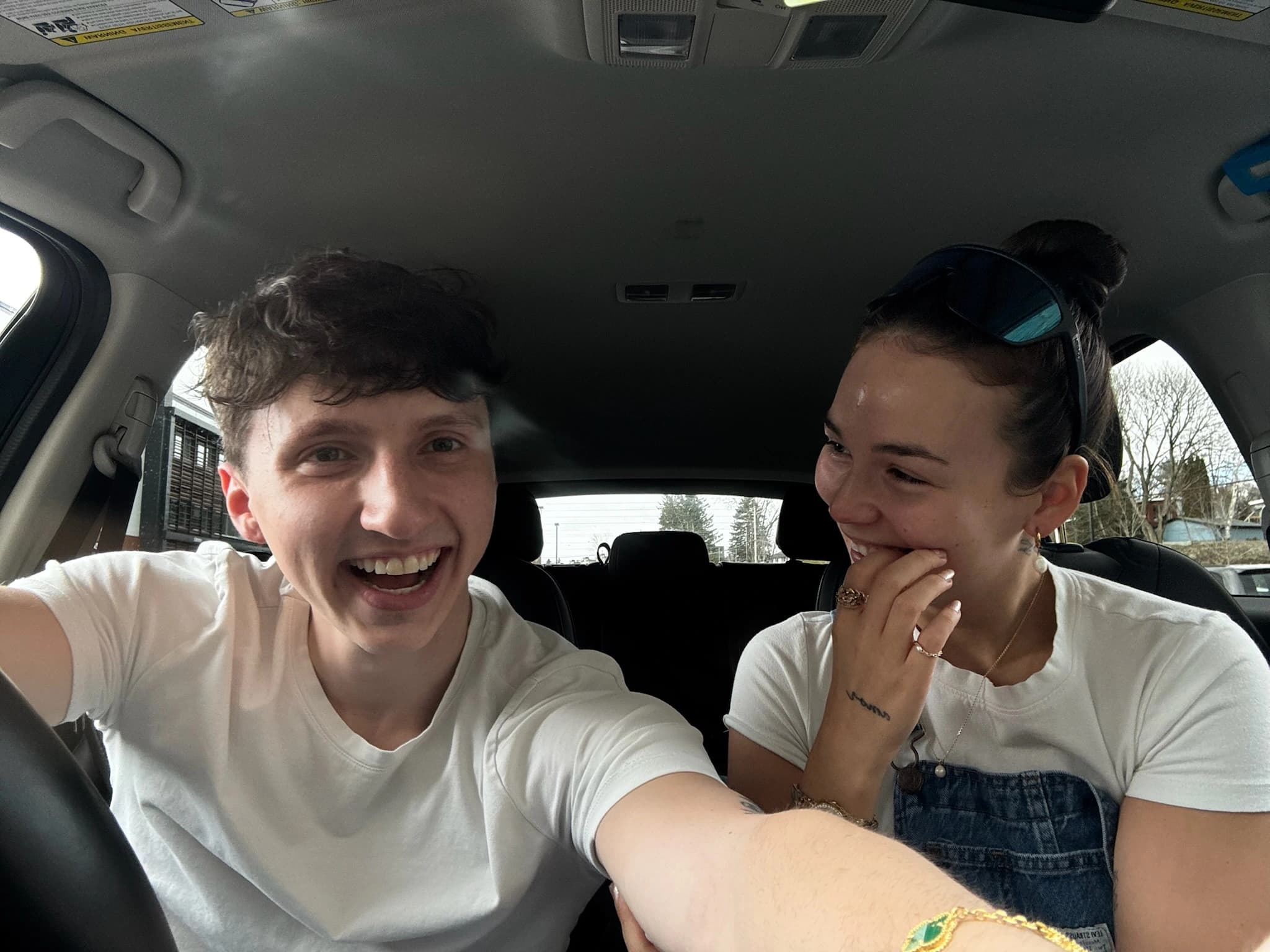 Laurence and a friend laughing in a car